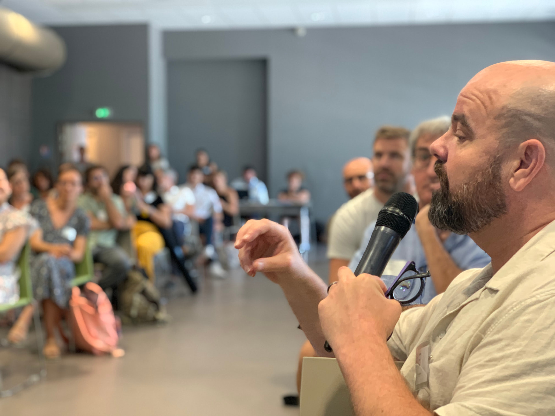 A researcher speaking into a microphone and answering questions from the audience at a scientific conference